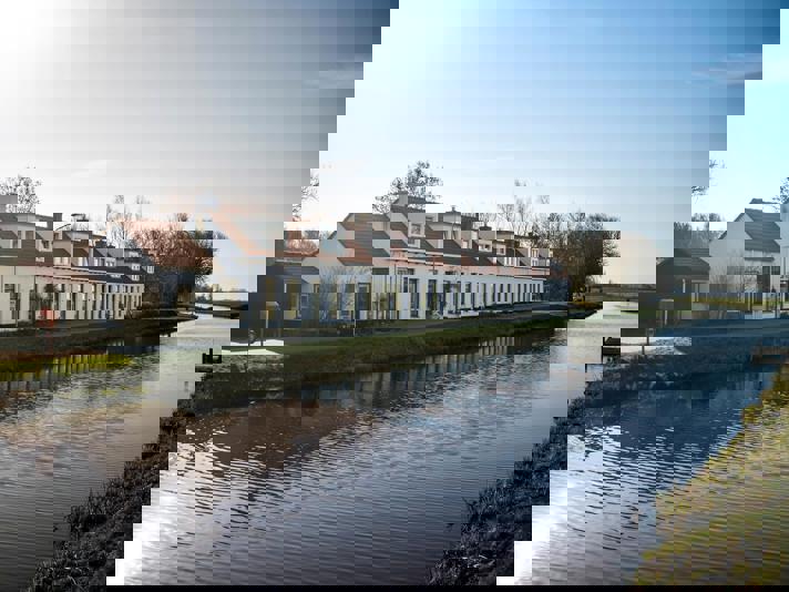 Blok van 10 witte woningen aan de Scharmer Ae.