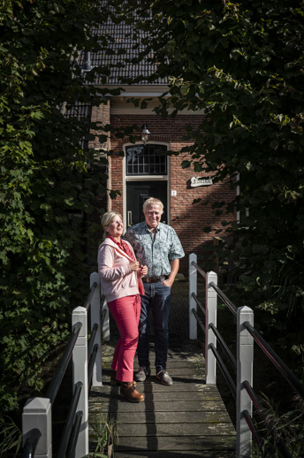 Ineke en Wim van Zanten staan op het bruggetje naar hun boerderij.