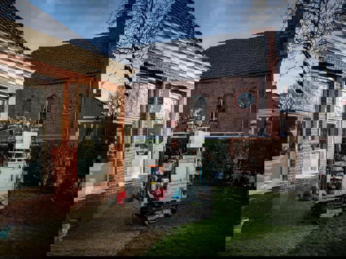 In de tuin van een woning wordt constructief onderzoek uitgevoerd.